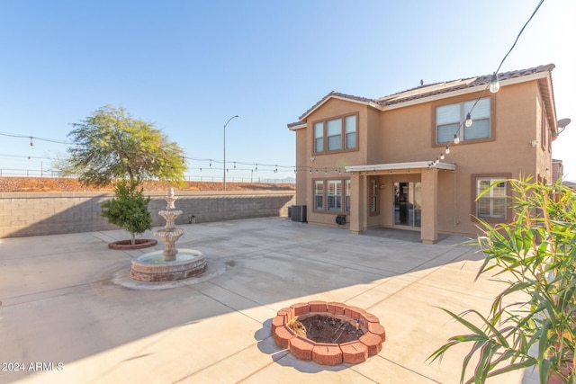 rear view of property featuring a patio and central air condition unit