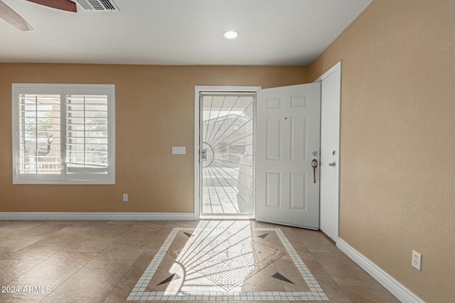 tiled entryway with ceiling fan