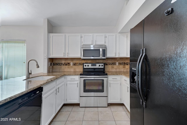 kitchen featuring white cabinetry, a sink, black appliances, and light tile patterned floors