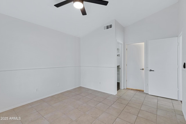 spare room featuring light tile patterned floors, visible vents, and a ceiling fan