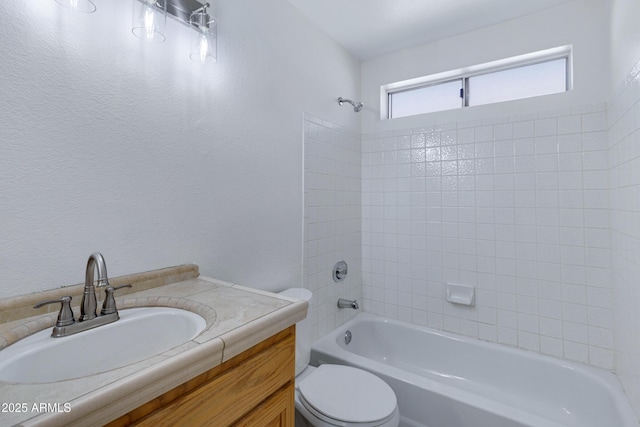 bathroom with shower / bathing tub combination, vanity, and toilet