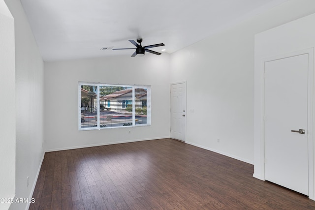 spare room featuring visible vents, baseboards, a ceiling fan, lofted ceiling, and dark wood-style floors