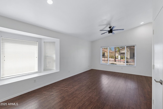 unfurnished room featuring lofted ceiling, ceiling fan, dark wood-type flooring, and baseboards