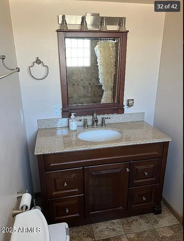 bathroom featuring vanity and toilet