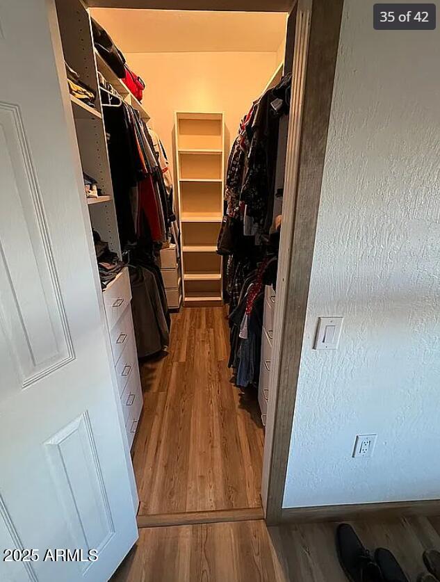 spacious closet with wood finished floors