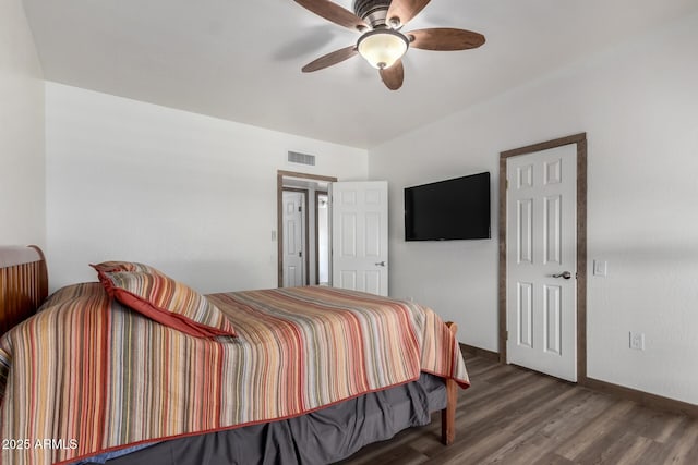 bedroom featuring visible vents, ceiling fan, baseboards, and wood finished floors