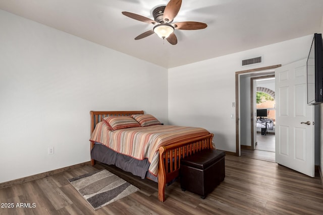 bedroom featuring baseboards, visible vents, ceiling fan, and wood finished floors