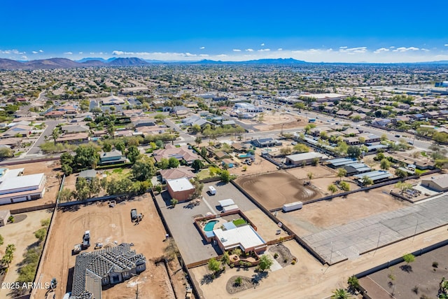 birds eye view of property with a mountain view