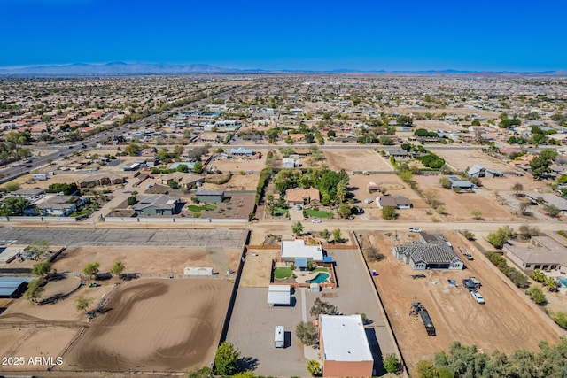 drone / aerial view featuring a mountain view and a desert view