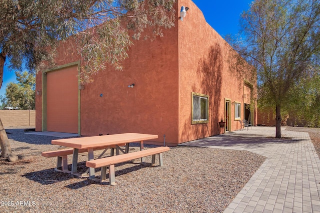 view of side of property featuring a patio area and stucco siding