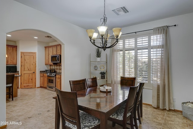 dining space with a chandelier