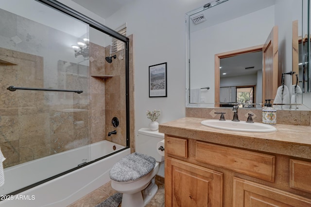 full bathroom featuring vanity, tile patterned floors, toilet, and combined bath / shower with glass door