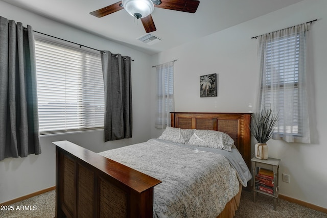 bedroom with ceiling fan and light carpet