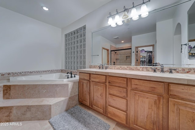 bathroom with tile patterned flooring, plus walk in shower, and vanity