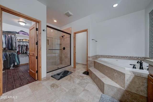 bathroom featuring independent shower and bath