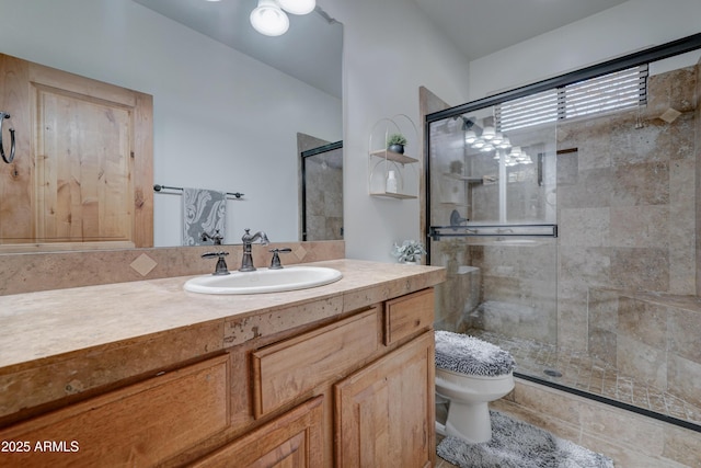 bathroom with vanity, toilet, and an enclosed shower