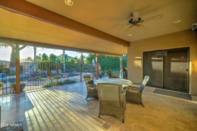 view of patio featuring a swimming pool and ceiling fan