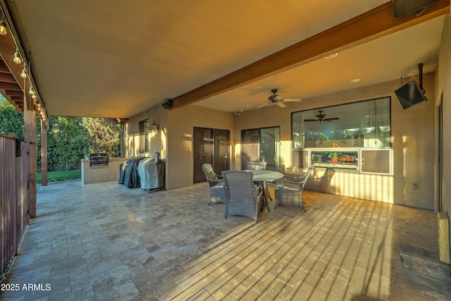 view of patio with grilling area, ceiling fan, and exterior kitchen