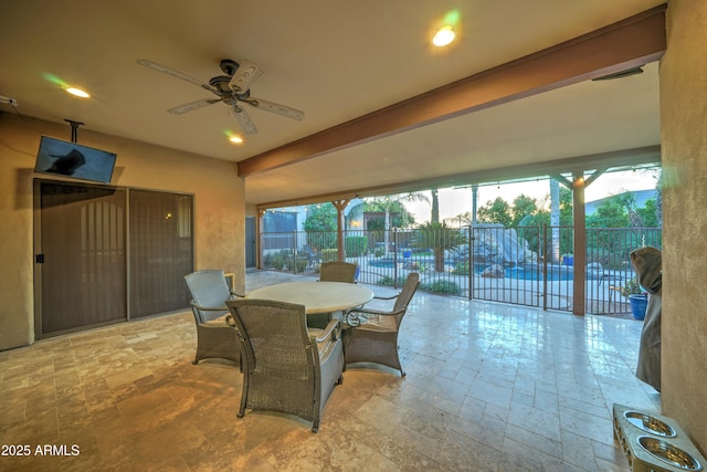 sunroom featuring ceiling fan