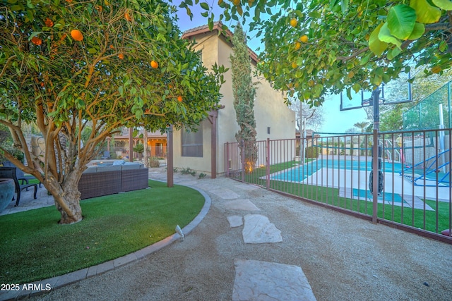 view of home's community featuring a pool, a patio, outdoor lounge area, and a lawn