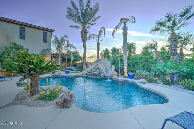 pool at dusk featuring a patio, a pergola, and pool water feature