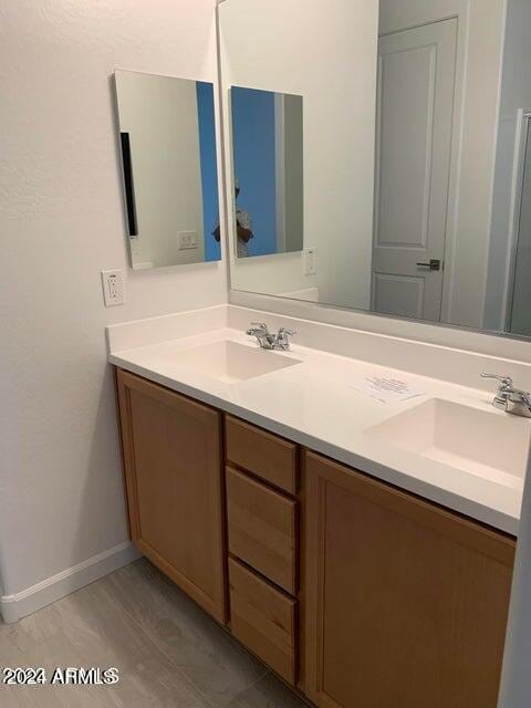 bathroom with vanity and hardwood / wood-style floors