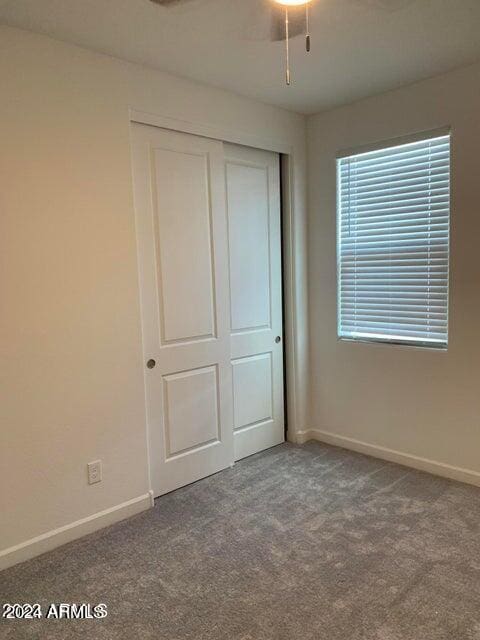 unfurnished bedroom with carpet and a closet