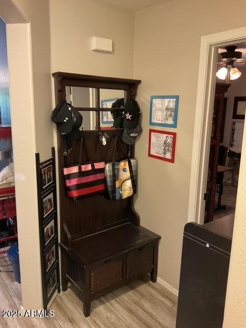 mudroom featuring wood finished floors, a ceiling fan, and baseboards