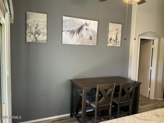dining space featuring wood finished floors and a ceiling fan