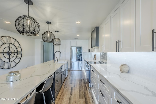 kitchen featuring stainless steel appliances, recessed lighting, and white cabinetry