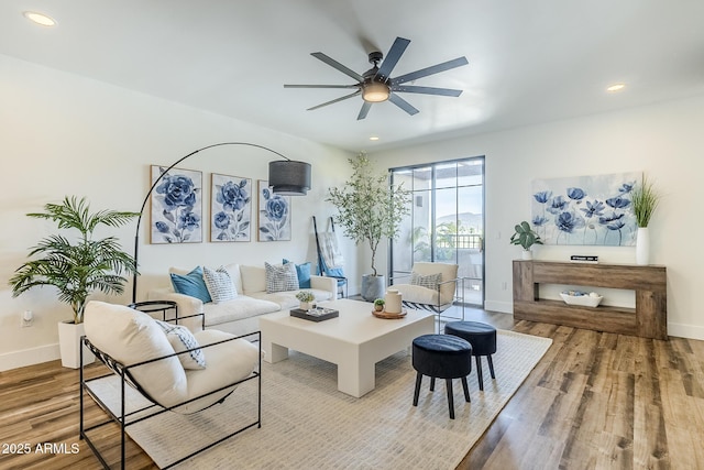 living room featuring baseboards, ceiling fan, recessed lighting, and wood finished floors