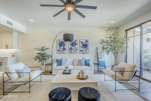 living area featuring recessed lighting, a ceiling fan, light wood-type flooring, and visible vents