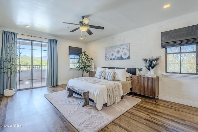bedroom with access to outside, baseboards, and wood finished floors
