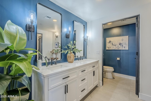 full bath with a sink, tile patterned flooring, toilet, and double vanity