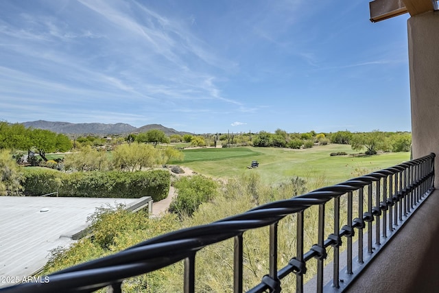 balcony with view of golf course and a mountain view