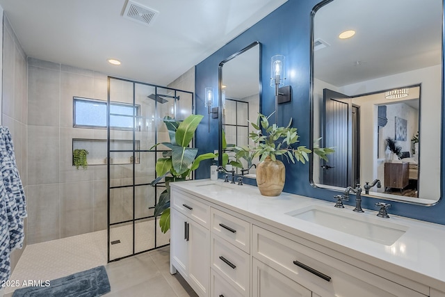 full bathroom featuring visible vents, a sink, double vanity, and tiled shower