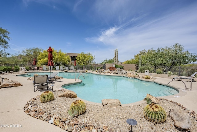 community pool featuring a patio and fence