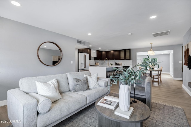 living room with sink and hardwood / wood-style floors