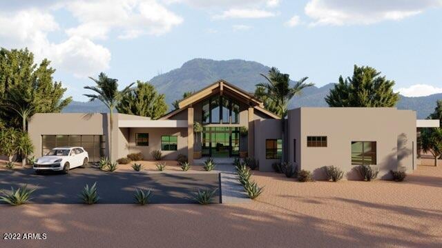 view of front of home with a garage and a mountain view