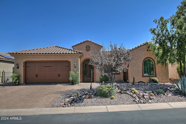 mediterranean / spanish-style home with a garage