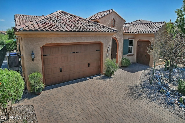 mediterranean / spanish home with a garage