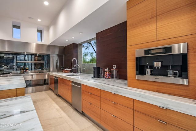 kitchen with a high ceiling, sink, light stone counters, and decorative backsplash