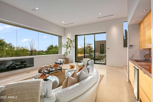 living room with sink and light tile patterned floors