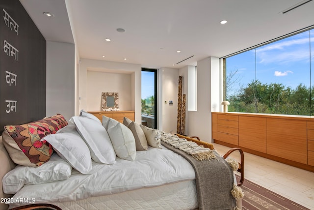 bedroom featuring expansive windows and wood-type flooring