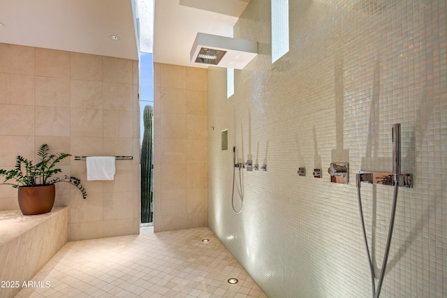 bathroom with tile walls, tile patterned floors, and walk in shower