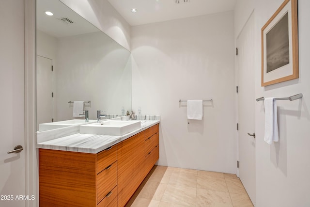 bathroom with tile patterned flooring and vanity