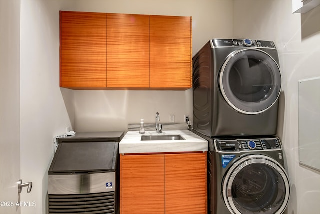 laundry area with stacked washer and dryer, sink, and cabinets