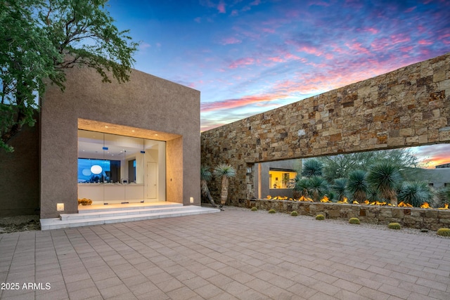 view of patio terrace at dusk