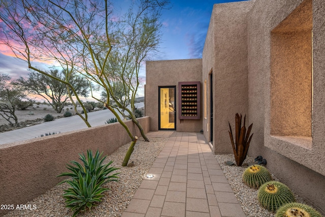 view of exterior entry at dusk