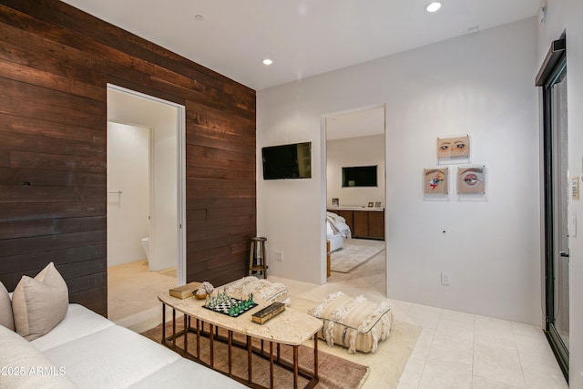 tiled living room featuring wood walls